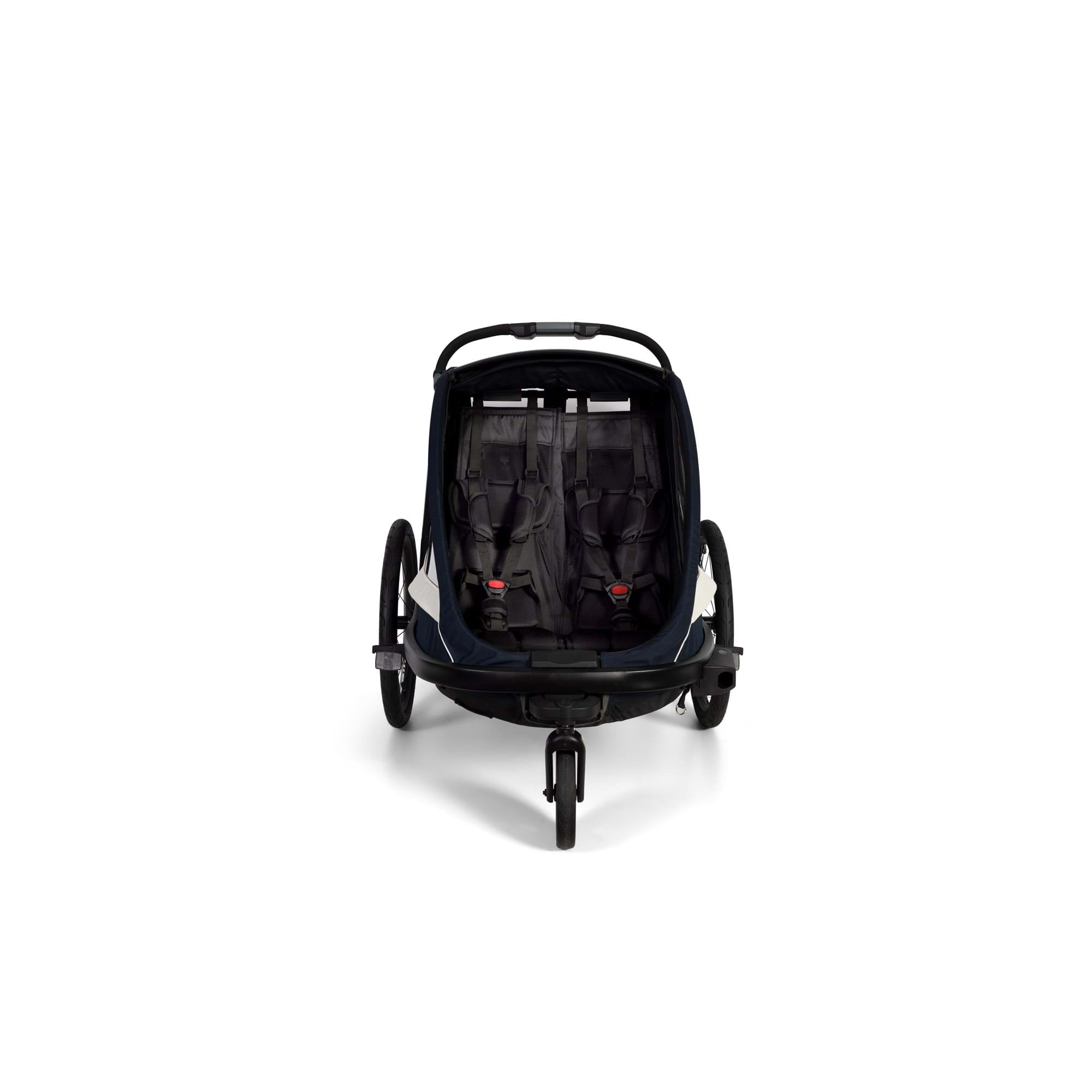 Hamax Breeze twin child bike trailer with stroller conversion and safety features, designed for family outdoor activities.