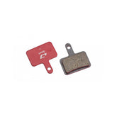 Jagwire Sport semi-metallic disc brake pads for Shimano and Promax systems, red color, bicycle components for stopping power.