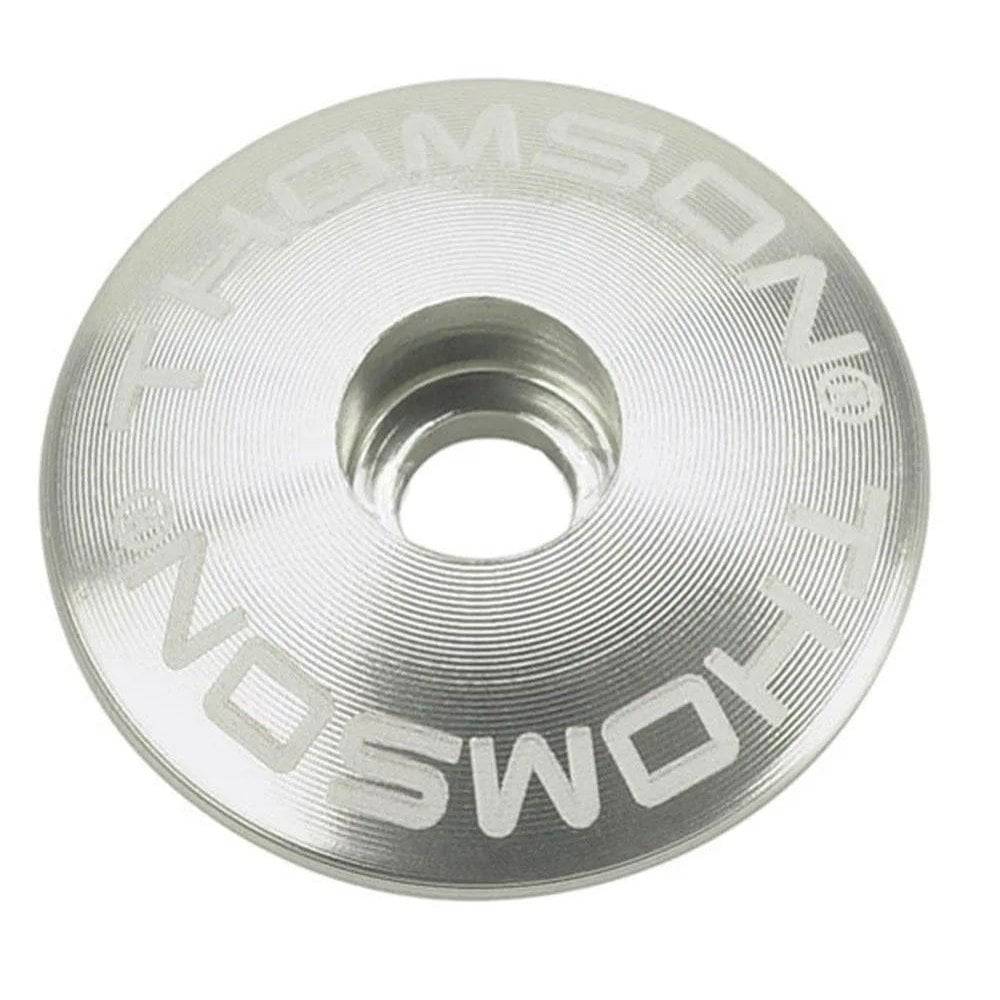 Black Thomson 1 1/8 stem cap spare part for bicycle stems, showing the component and branding on the product.