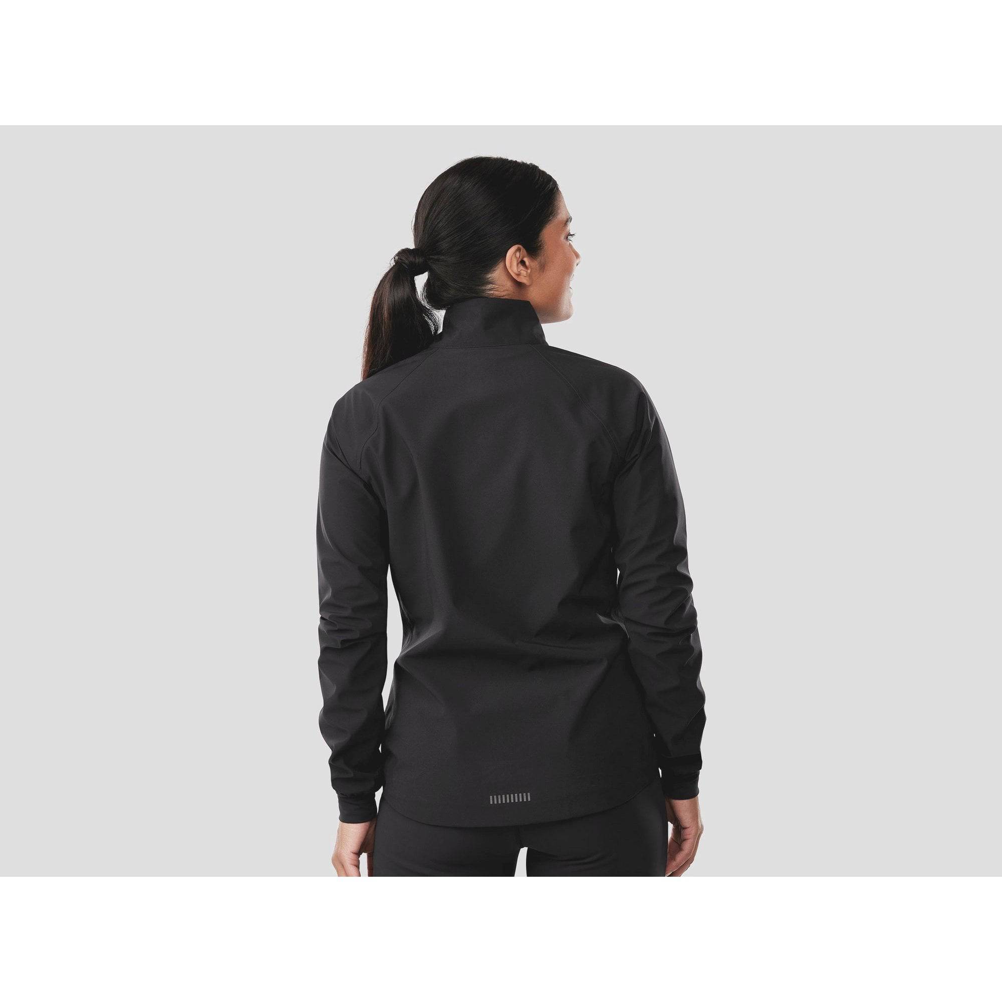 Trek Circuit Women's waterproof rain cycling jacket, lightweight and packable, shown in a vibrant color on a model.