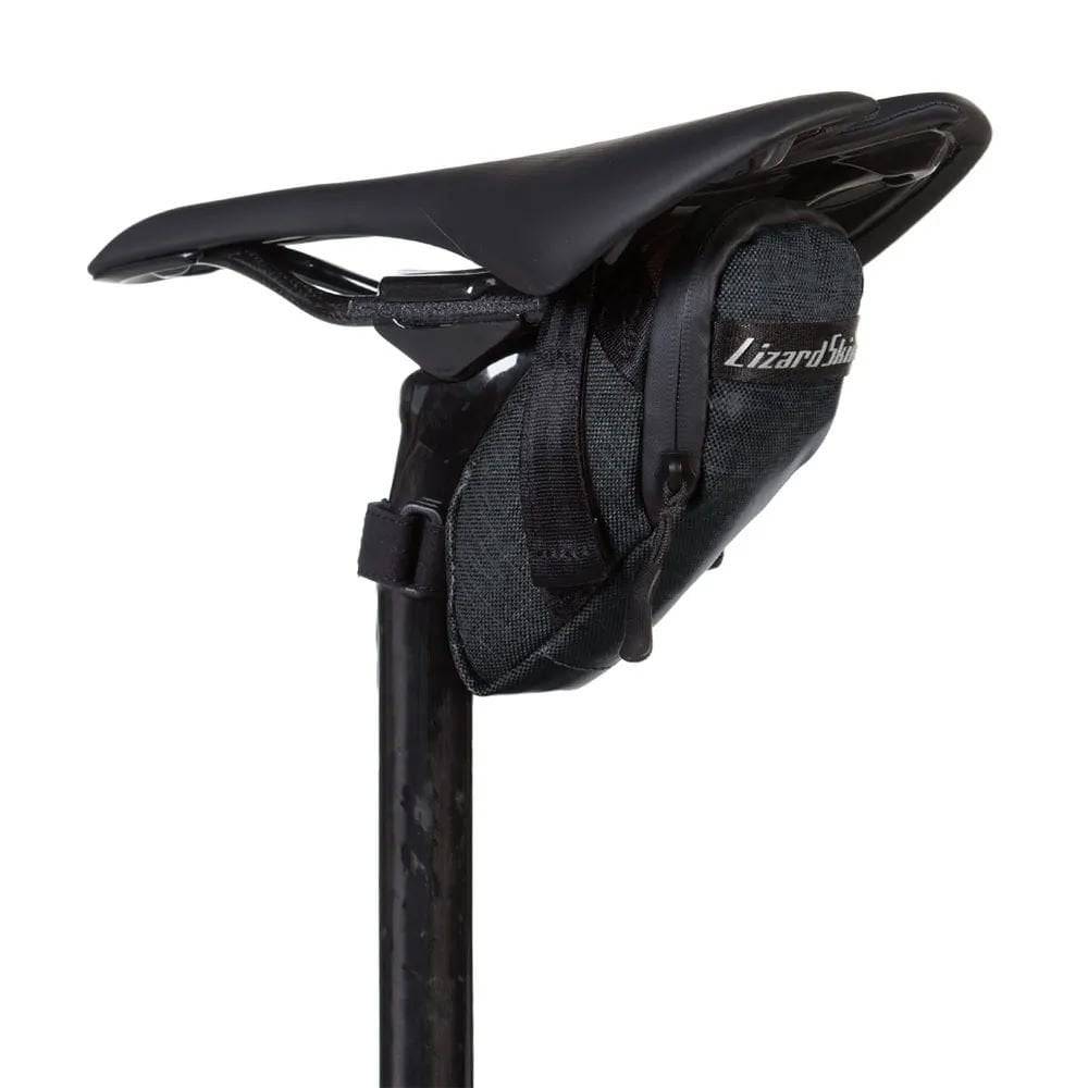 Lizard Skins Micro Cache saddle bag in jet black, lightweight bike storage accessory attached to a bicycle saddle.