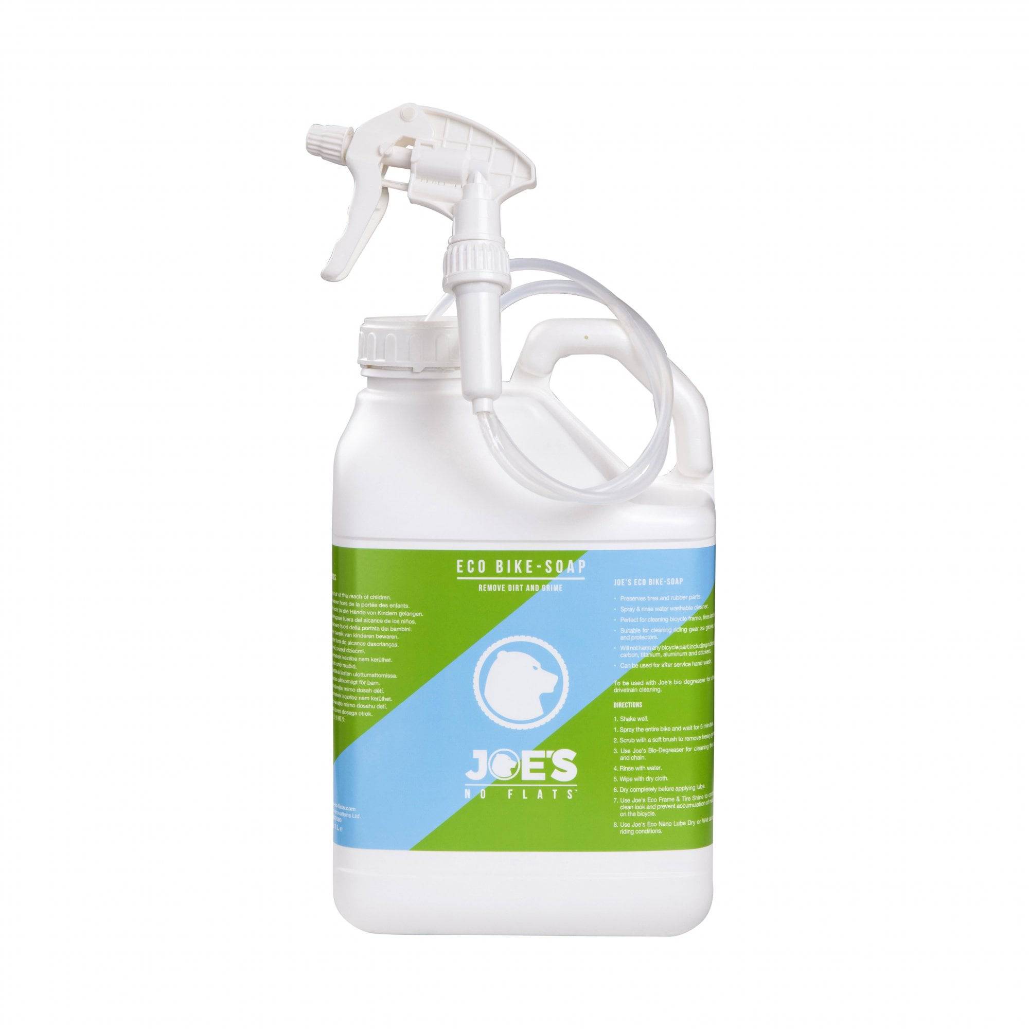 Joe's No Flats Eco Bike Soap in a workshop setting, natural and safe cleaner for bikes and gear, with soap bottle and bike parts visible