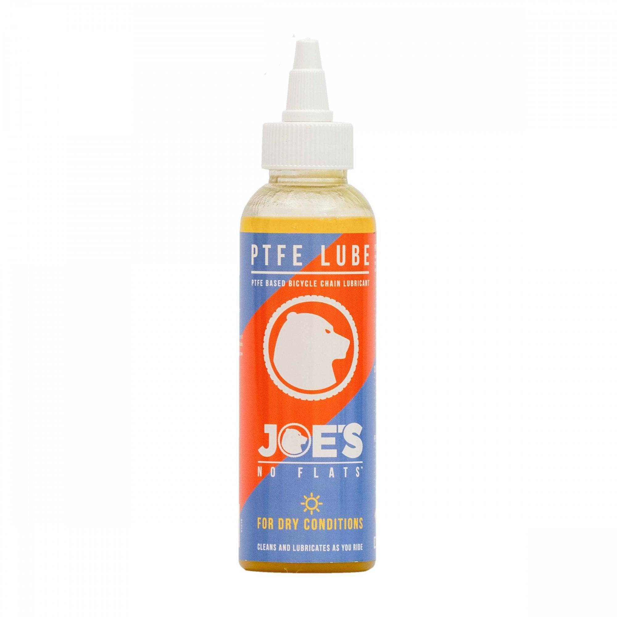Joe's No Flats PTFE Dry Lube applied to a bicycle chain and drivetrain during workshop maintenance.