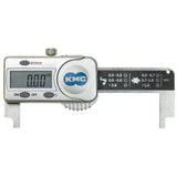 KMC digital bike chain checker tool used for measuring chain wear, shown on a workshop workbench with bike components.