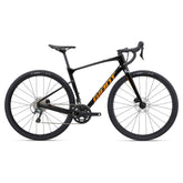 Giant Revolt Advanced 3 2024 gravel bike with Shimano GRX 400 groupset and disc brakes, shown from side view with knobby tires.