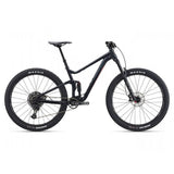 Giant Stance 29 mountain bike with full suspension and FlexPoint system, black and red frame, ready for trail riding.