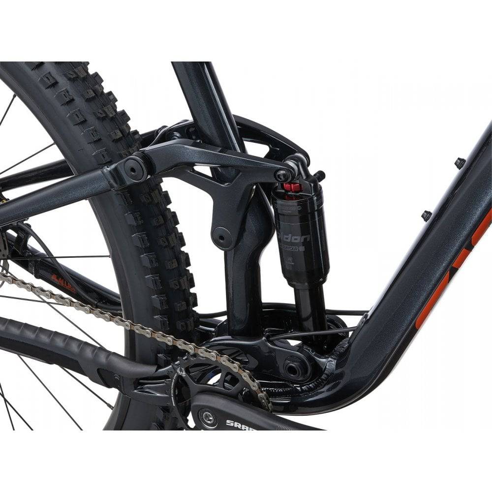 Giant Stance 29 1 full suspension mountain bike with FlexPoint suspension system, shown with rugged trail background.