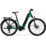Merida eSpresso CC 400 EQ e-hybrid bike with Shimano STEPS motor, 27.5-inch tires, integrated lights, mudguards, rack, lock, and suspension forks.