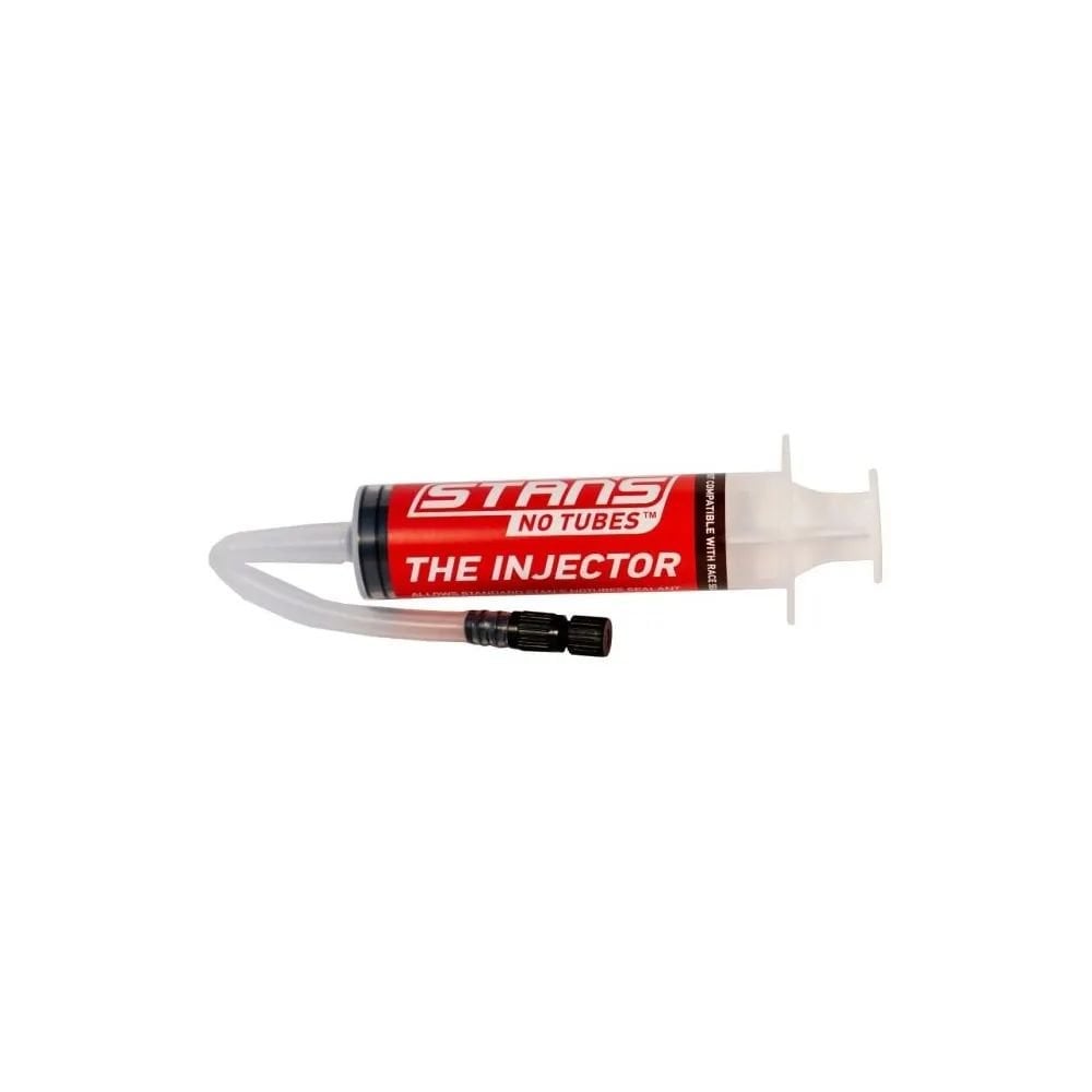 Stan's No Tubes tyre sealant injector for tubeless tires, compatible with Presta and Schrader valves, shown with injector tool and valves.
