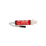 Stan's No Tubes tyre sealant injector for tubeless tires, compatible with Presta and Schrader valves, shown with injector tool and valves.
