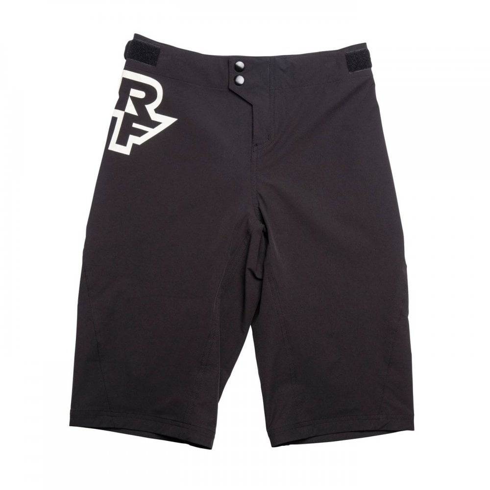 Race Face Sendy Youth mountain bike shorts with adjustable waist and zippered pockets, designed for active cycling wear.