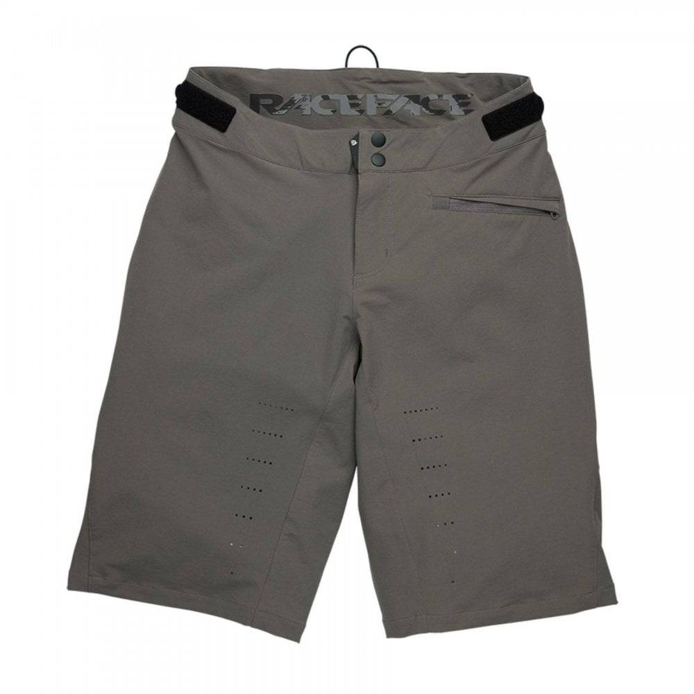 Race Face Indy women's mountain bike shorts with adjustable waist and zippered pockets, designed for outdoor cycling comfort.
