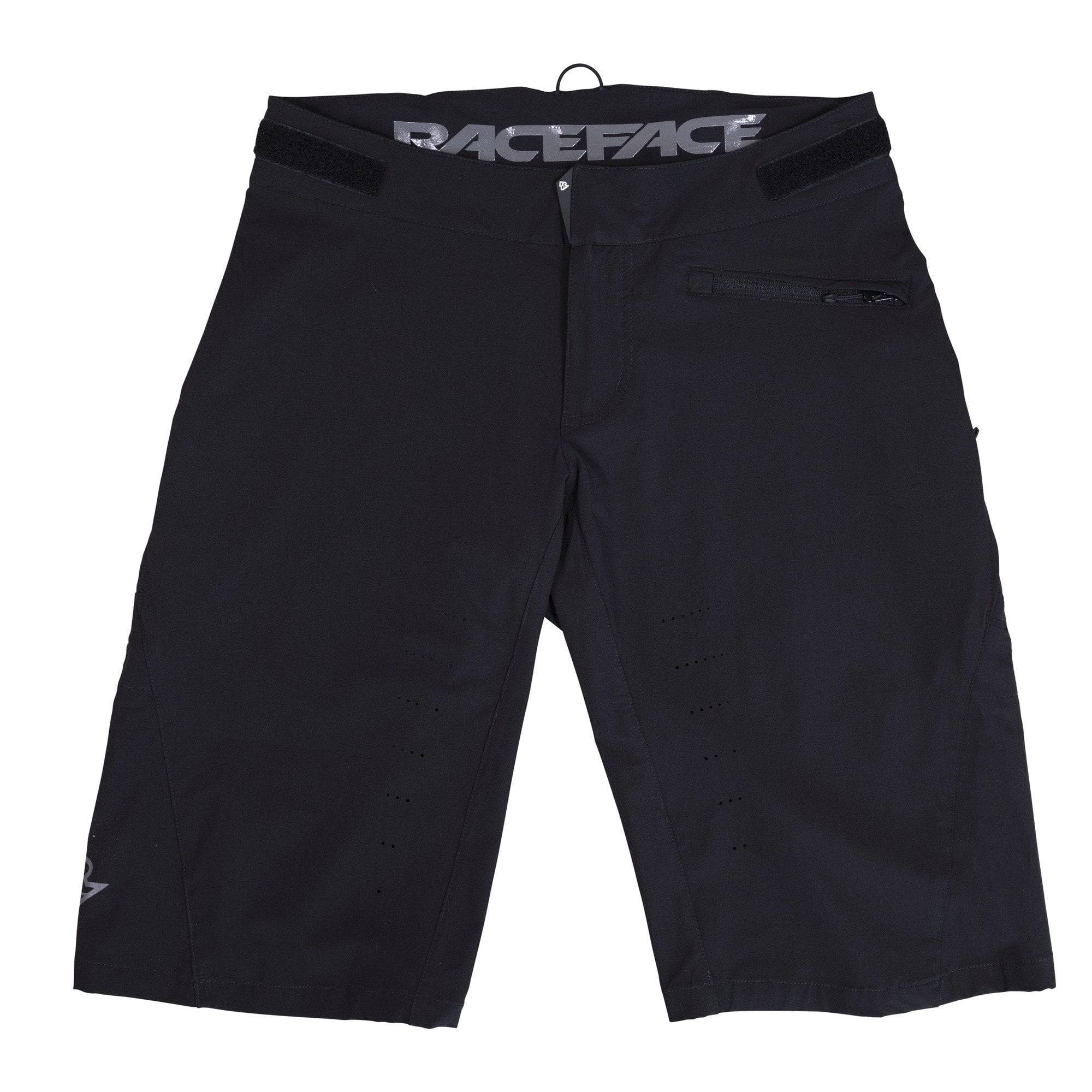 Race Face Indy Women's All-Mountain Shorts 2021 with venting and adjustable waistband, shown on a model in a mountain biking setting.
