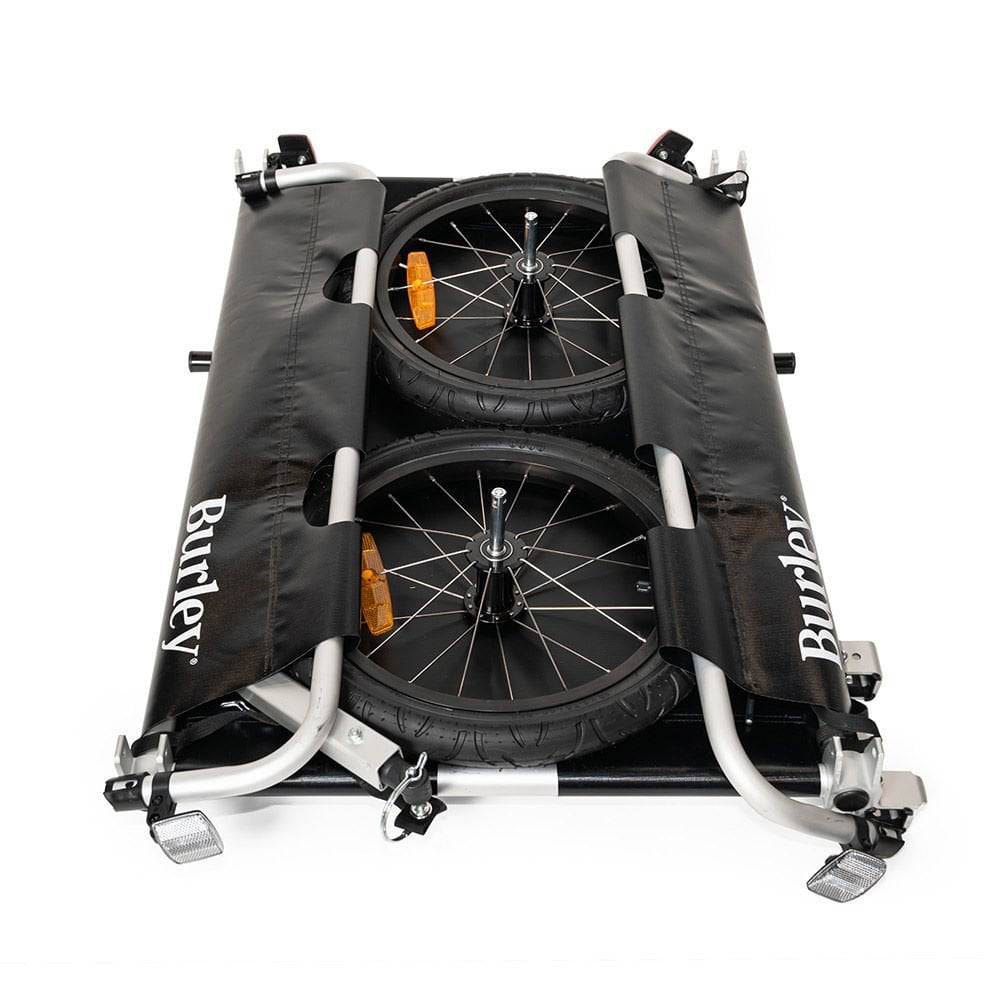 Burley Flatbed Cargo Bike Trailer with foldable two-wheel design for hauling bulk loads, shown attached to a bike.