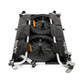 Burley Flatbed Cargo Bike Trailer with foldable two-wheel design for hauling bulk loads, shown attached to a bike.