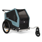 Burley Bark Ranger XL pet trailer attached to a bike, showing the durable outdoor fabric and spacious interior for pets.