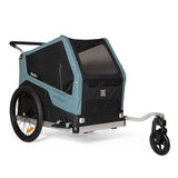 Burley Bark Ranger XL pet trailer attached to a bike, showing the durable outdoor fabric and spacious interior for pets.