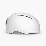 MET Vibe Mips helmet with integrated USB LED light for urban e-bike safety, shown on a rider wearing the helmet outdoors.