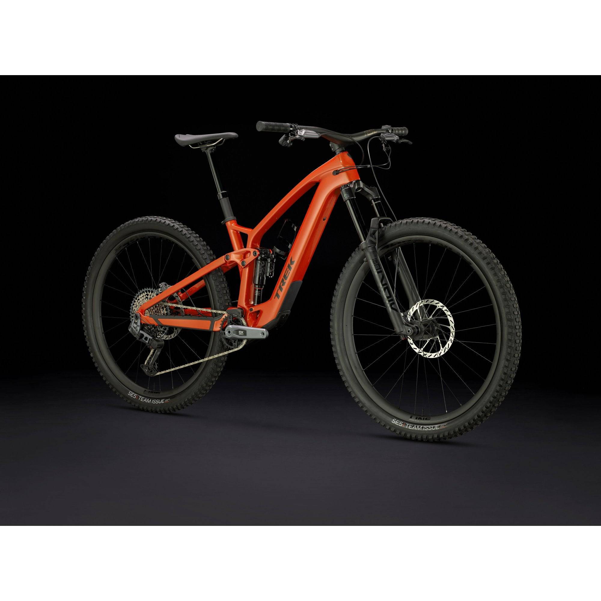Trek Fuel EXe 9.8 GX AXS T-Type 29er e-Mountain Bike with SRAM wireless shifting, black and red frame, mountain trail background