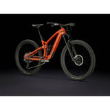 Trek Fuel EXe 9.8 GX AXS T-Type 29er e-Mountain Bike with SRAM wireless shifting, black and red frame, mountain trail background