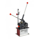Trek bike spoke cutter and threader tool in black and silver, used for bike wheel maintenance, shown on a workshop workbench.