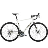 Trek Domane AL 4 Gen 4 road bike with Shimano Tiagra 10-speed drivetrain and disc brakes, positioned on a scenic road.