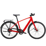 Trek FX+ 2 e-hybrid bike with HyDrive pedal assist, front lights, mudguards, and rear rack, ready for city commuting.