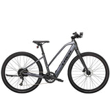 Trek Dual Sport+ 2 Stagger women’s e-hybrid bike with Shimano Altus M2000 gears and HyDrive motor, shown on a trail.