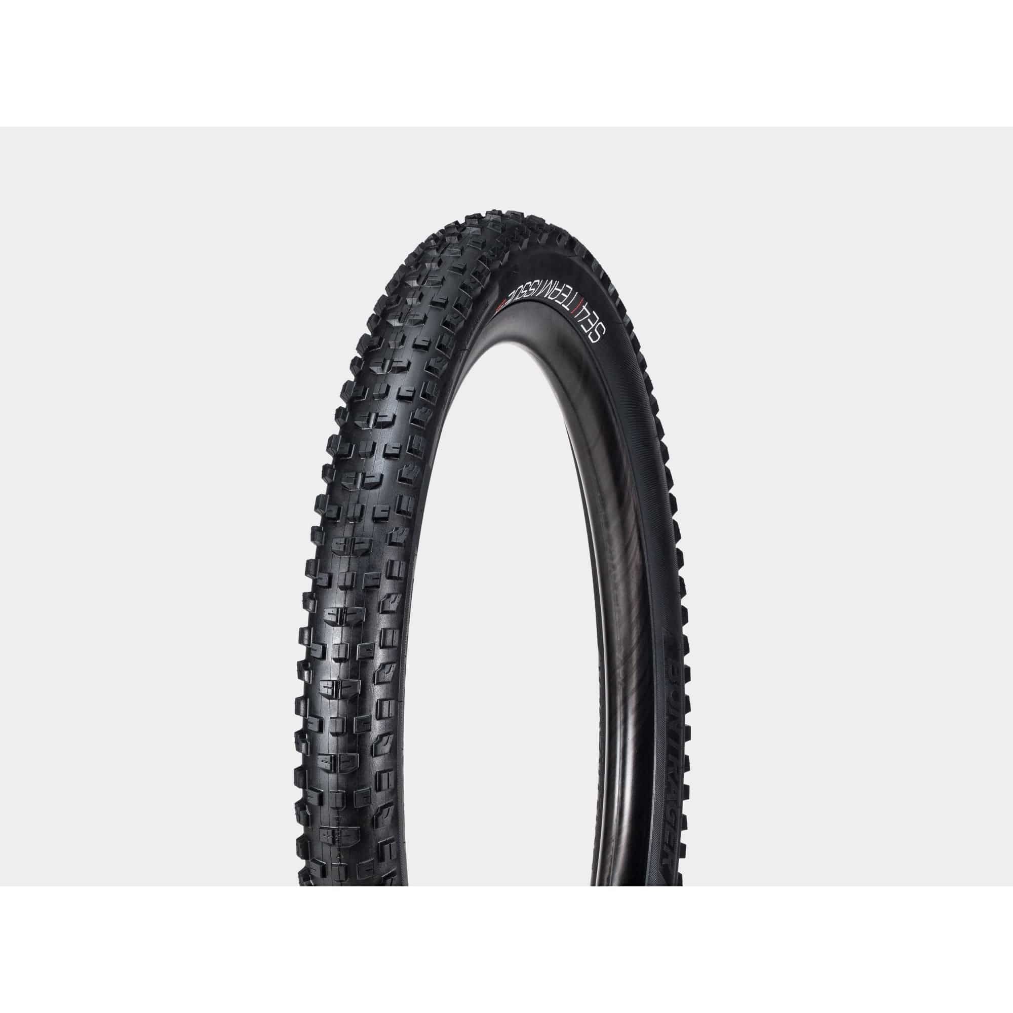 Bontrager SE4 Team Issue TLR MTB tire mounted on a bike, showing tread pattern and tubeless-ready sidewall for enduro racing and trail riding.