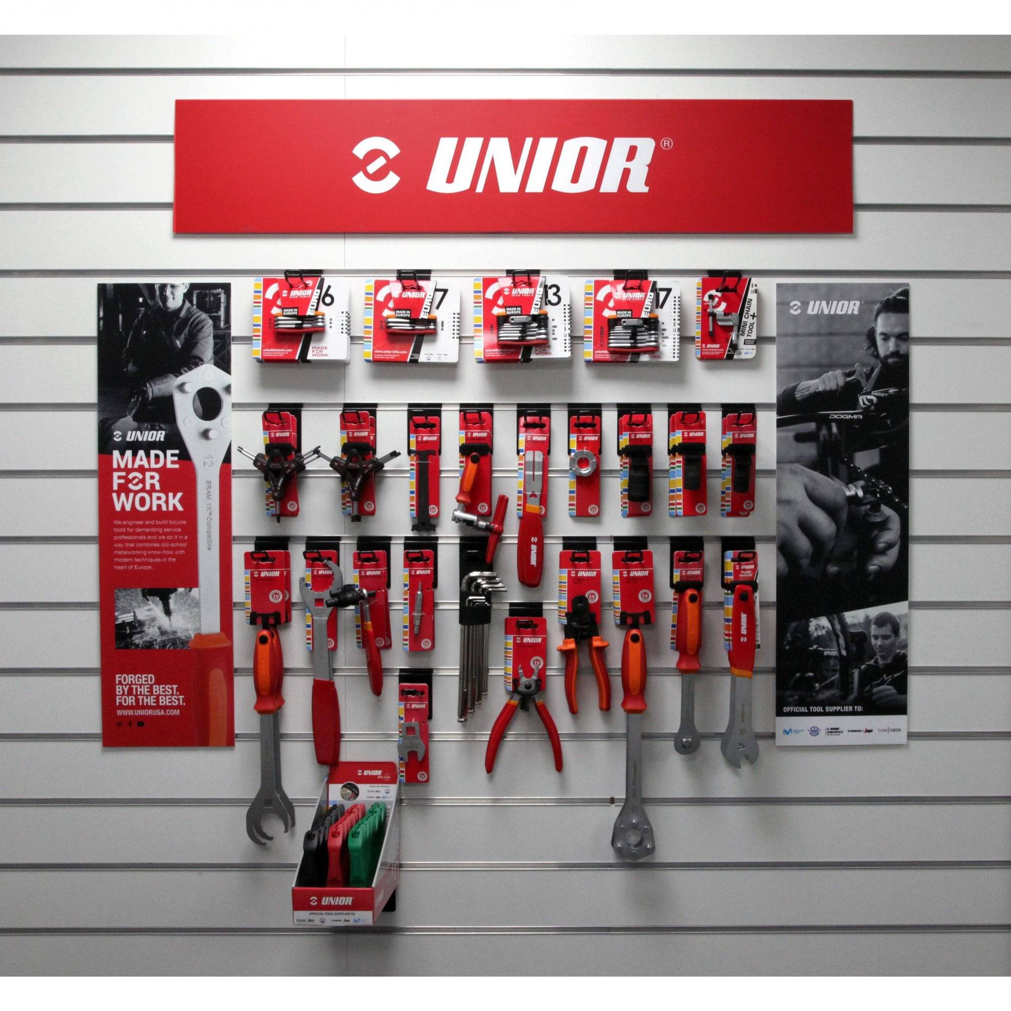 Unior retail pack with professional bike repair tools in red, displayed on point of sale workshop display.