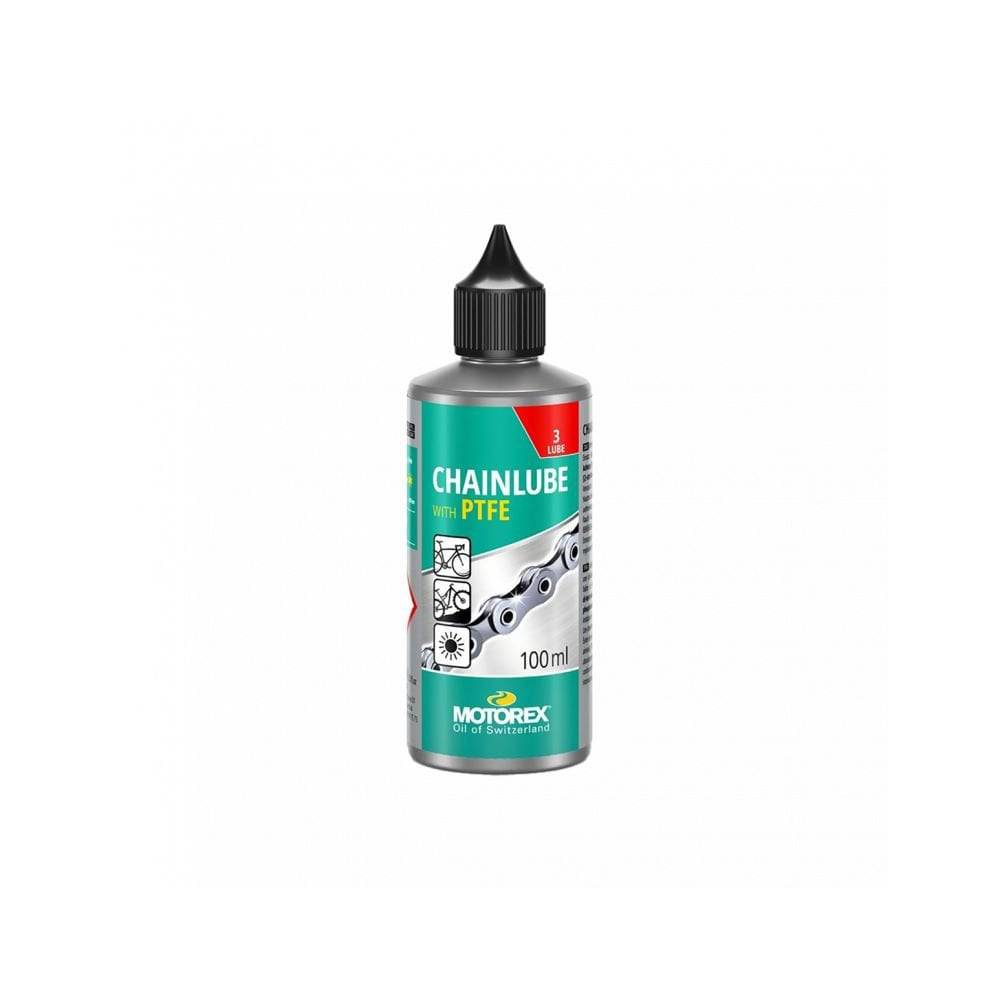 Motorex Chainlube with PTFE, 100ml, synthetic bike chain lubricant for dry conditions, with a workshop setting in the background.