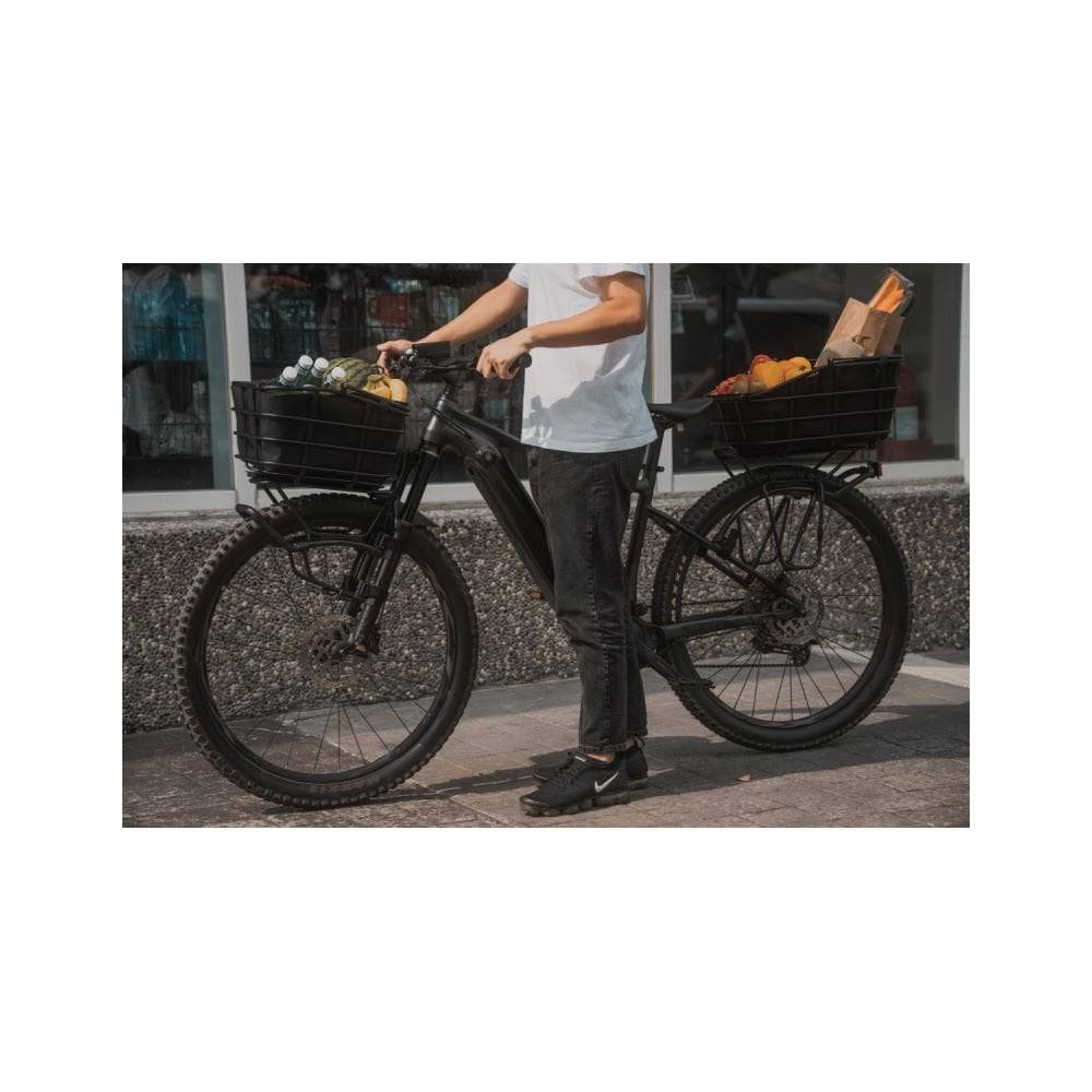 Topeak Urban Basket DX pannier bag mounted on bike rack, designed for MTX QuickTrack, MIK, and Racktime racks, with reflective accents.