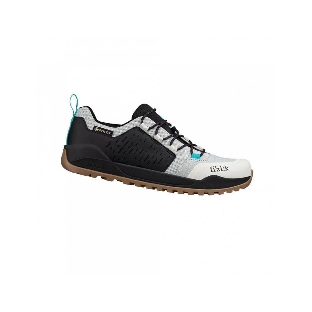 Fizik Terra Ergolace GTX waterproof flat MTB shoes with Vibram outsole, shown in a natural outdoor setting.