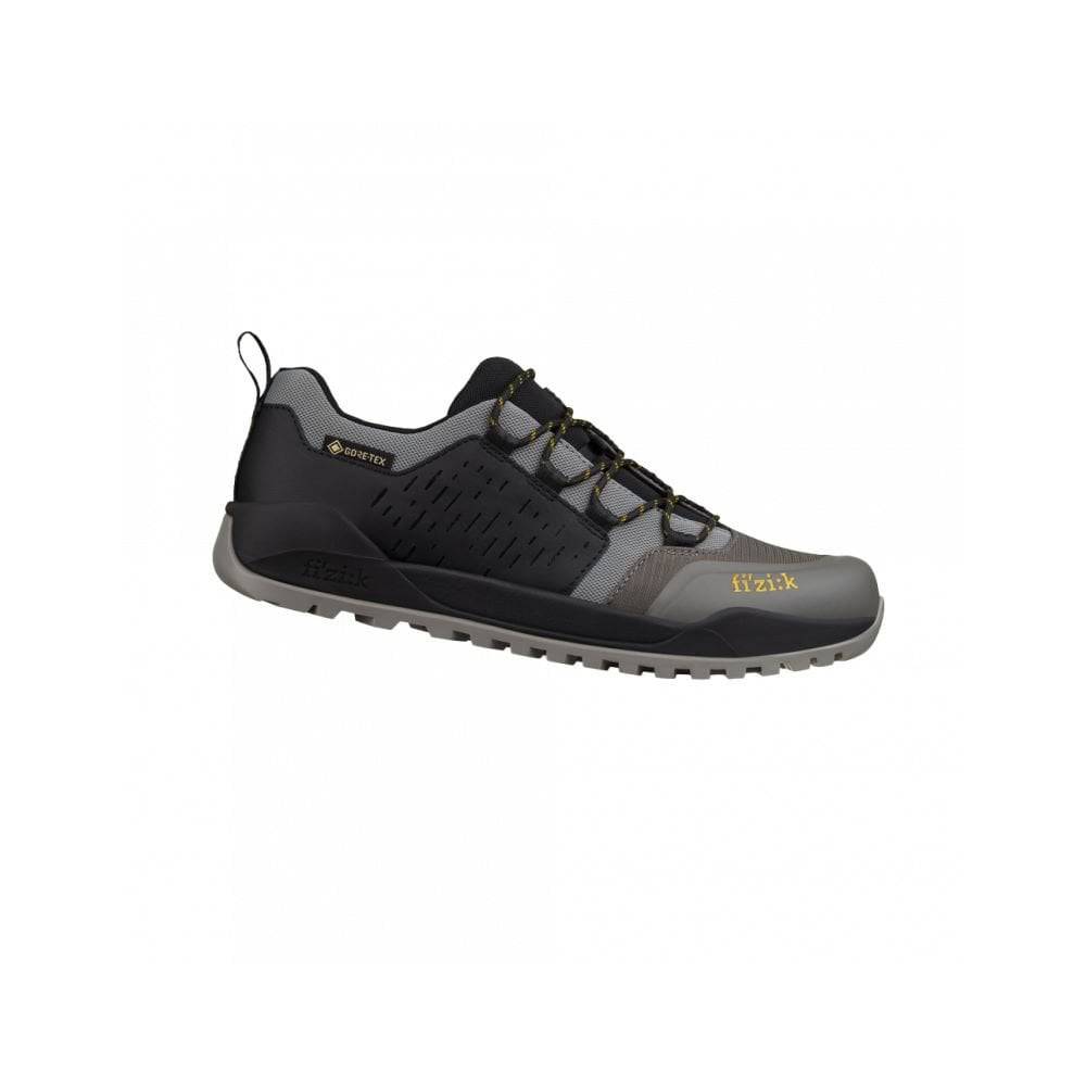 Fizik Terra Ergolace GTX waterproof flat MTB shoes with Vibram outsole, shown with breathable fabric and rugged sole for mountain biking.