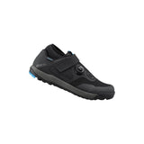 Shimano GF4 gravel shoes with ULTREAD® grip for flat pedals, shown in a natural outdoor setting, featuring durable design and laces