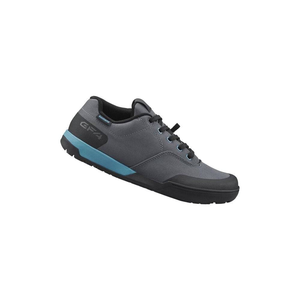 Shimano GF4W women's gravel cycling shoes with flat pedals and ULTREAD grip for secure riding on rugged terrain.