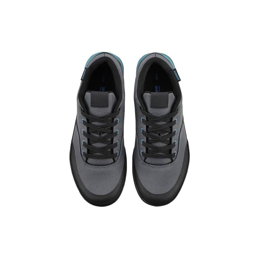Shimano GF4W women's gravel cycling shoes with flat pedals and ULTREAD grip for riding on rugged terrain.