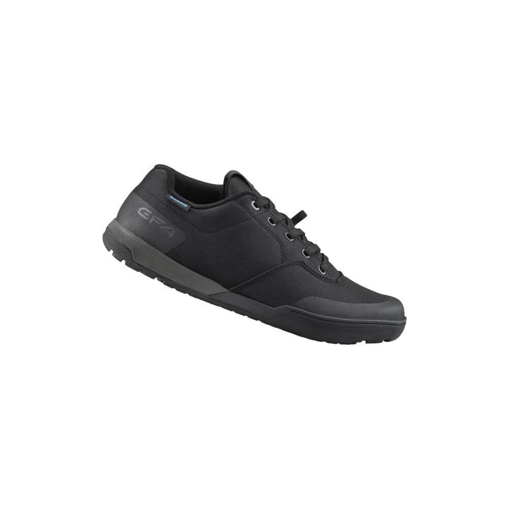 Shimano GF4 gravel shoes with ULTREAD® grip for flat pedals, featuring durable textile upper and cleat compatibility for cycling.