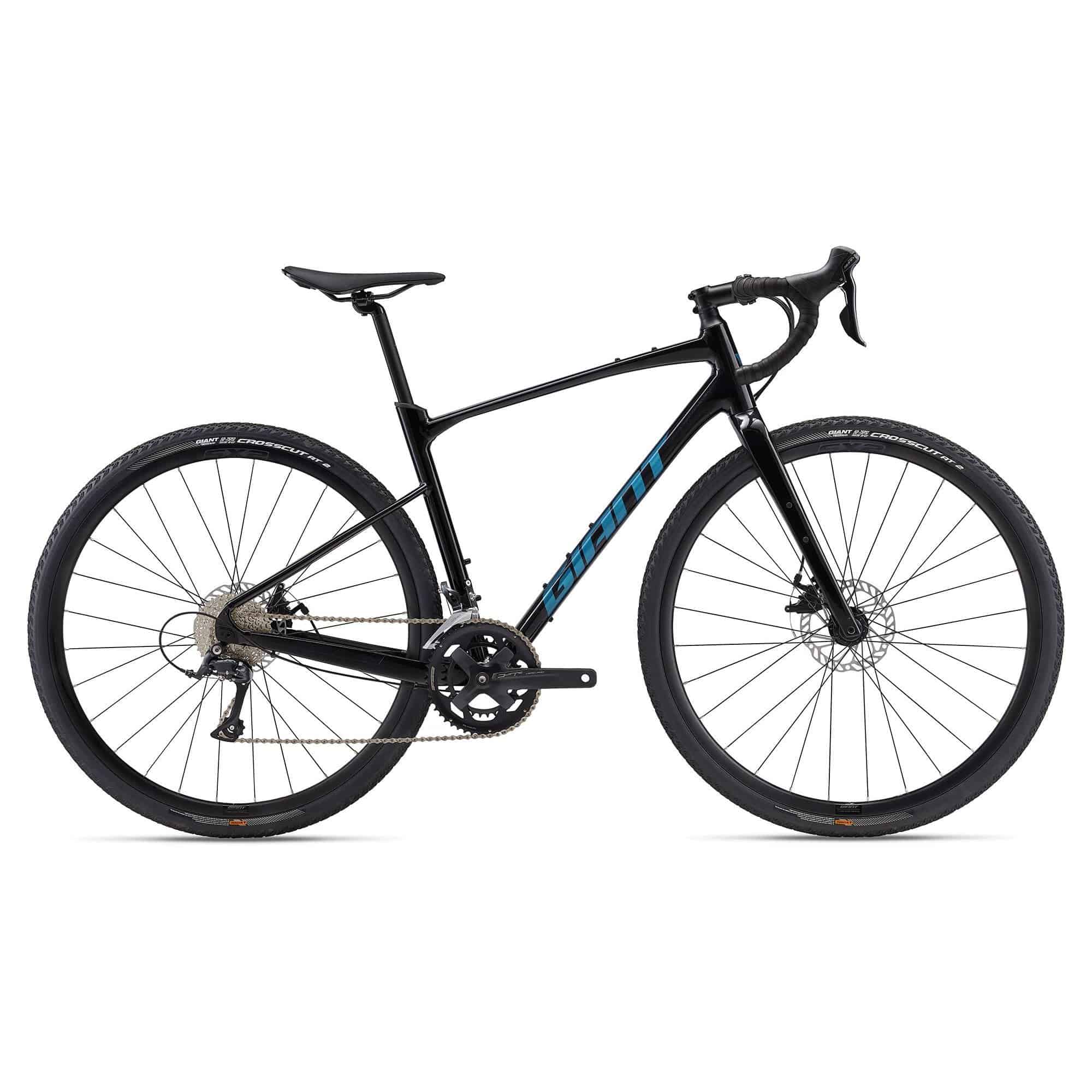 Giant Revolt 2 2024 gravel bike with Shimano Sora R3000 gears and disc brakes, unisex design, on rugged terrain.