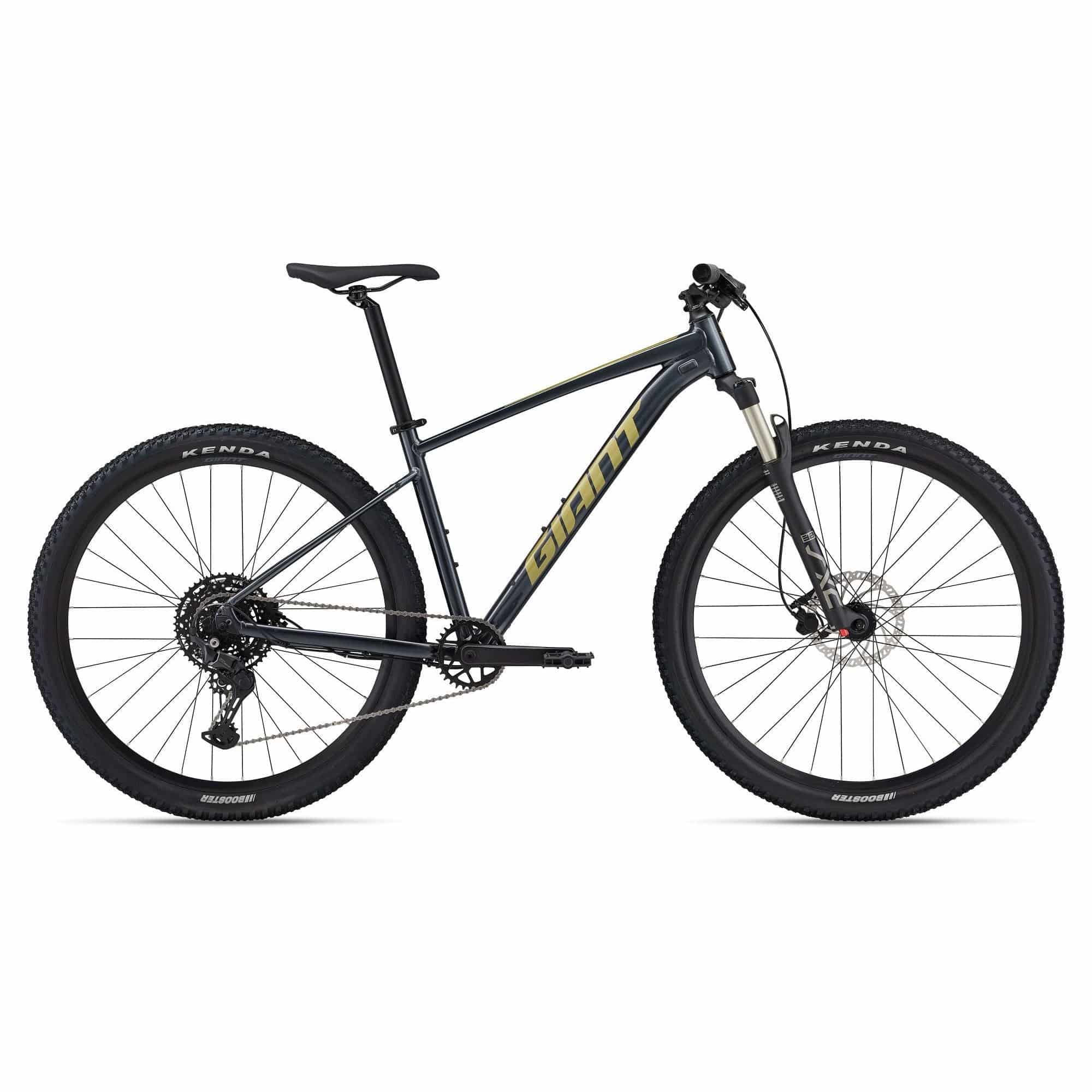 Giant Talon 1 2024 unisex mountain bike with Shimano CUES U6000 disc brakes, shown on rugged outdoor trail