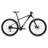 Giant Talon 3 2024 mountain bike with Shimano Acera drivetrain and disc brakes, shown on rugged trail.