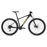 Giant Talon 3 2024 mountain bike with Shimano Acera drivetrain and disc brakes, shown on rugged trail.