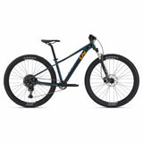 Liv Tempt 1 women’s mountain bike 2024 with Shimano CUES U6000 drivetrain, shown from a side view on a trail.