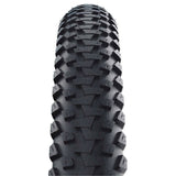 Schwalbe Marathon Plus MTB tyre with SmartGuard puncture protection, suitable for e-bikes, shown mounted on a mountain bike wheel.