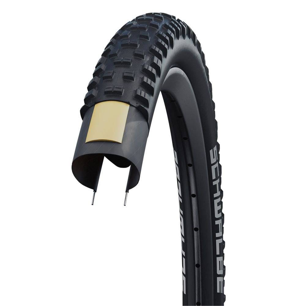 Schwalbe Tough Tom MTB tyre with K-Guard puncture protection, suitable for trail riding, mounted on a mountain bike wheel.