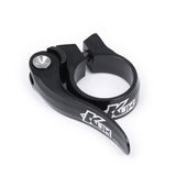 Black KUK Quick Release Seat Clamp for 28.6mm Kinesis seat posts, bicycle component by Upgrade, with quick-release lever.