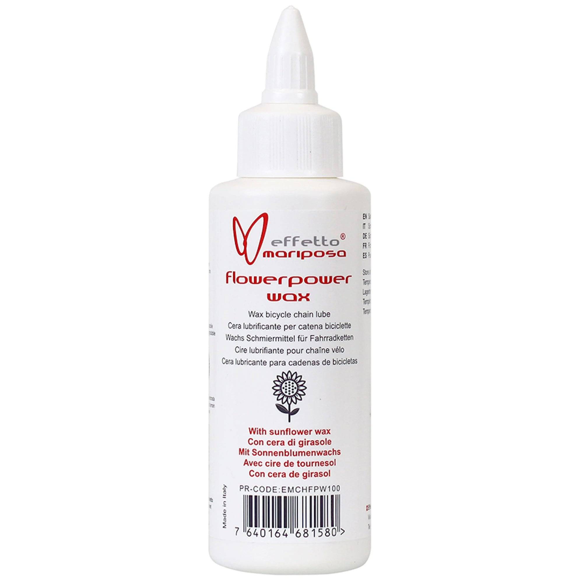 Effetto Mariposa Flowerpower chain lube wax in a workshop setting, eco-friendly bicycle chain lubricant in a container.