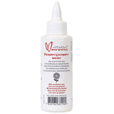 Effetto Mariposa Flowerpower chain lube wax in a workshop setting, eco-friendly bicycle chain lubricant in a container.