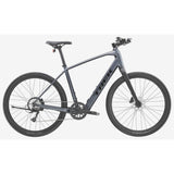 Trek Dual Sport+ 2 LT 2025 electric hybrid bike with mountain bike tires and sleek frame, suitable for urban and trail riding.