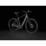 Trek Dual Sport+ 2 LT 2025 electric hybrid bike with sturdy frame, digital display, and fat tires for urban and trail riding.